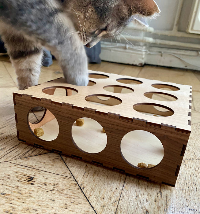 Our cat minou hunting for treats in his wooden Pawzzle