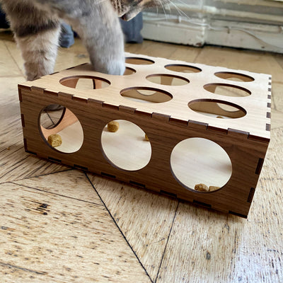 Our cat minou hunting for treats in his wooden Pawzzle